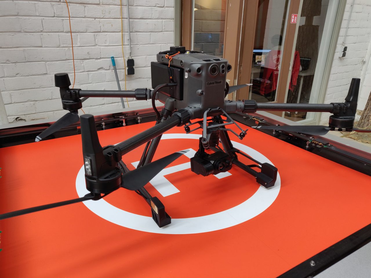 Cybrid Thrust drone on landing pad inside the station